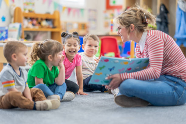 teacher reading a book to pupils